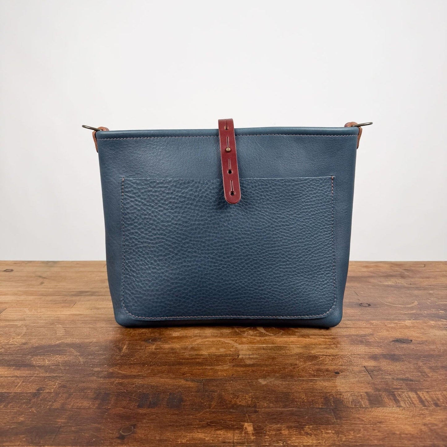 AVERY CROSSBODY - SMALL - SMOKEY BLUE - SADDLE STRAPS - LARGE FRONT POCKET - HEMMED TOP - BUTTON STUD - IN STOCK